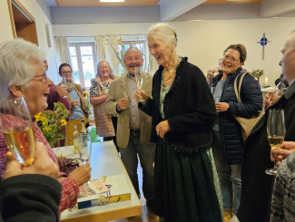 Die Festgesellschaft stößt mit Barabra Landes und Sekt auf ihr Jubiläum an.
